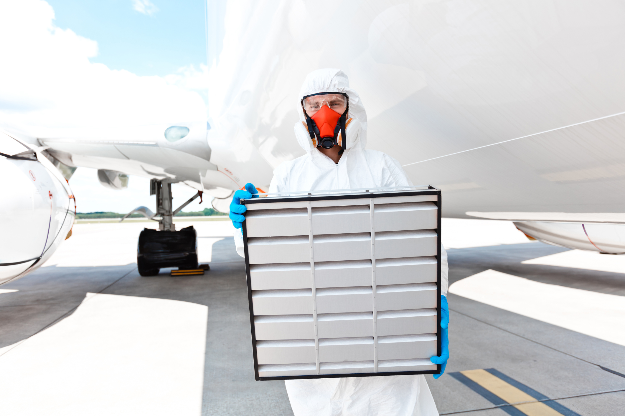 Aircraft cleaner in protective suit at the airport