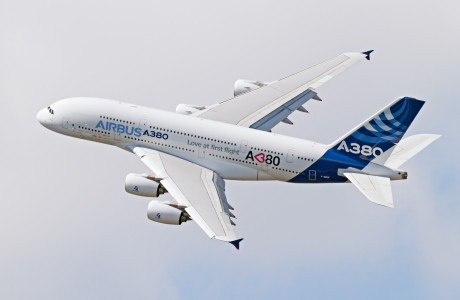 An Airbus A380 in the air, the aircraft bears the inscription "Love at first flight".