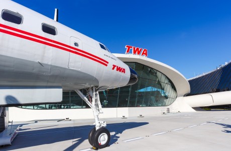A TWA aircraft stands in front of the TWA Flight Center.